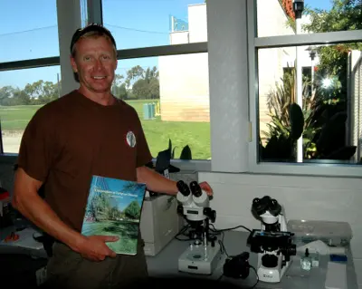Mike Greninger with microscopes