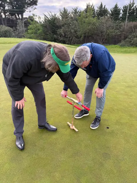 using a shear strength tester on a putting green