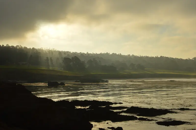 Filtered morning light on the Del Monte Forest. sun shining through clouds at Pebble Beach
